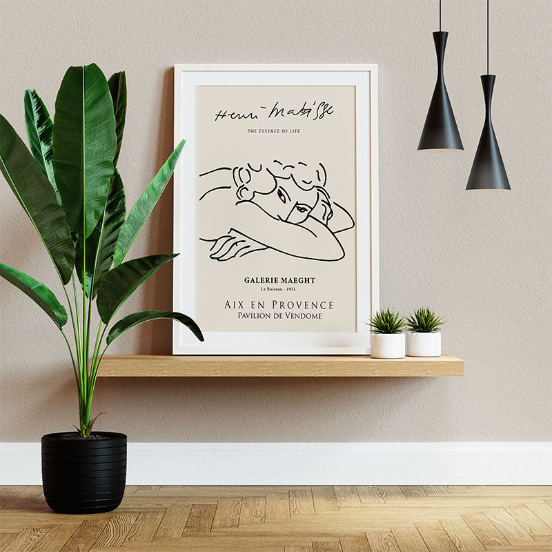 Quadro Minimalista Mulher Matisse Pendurado ao Lado de Planta Verde.